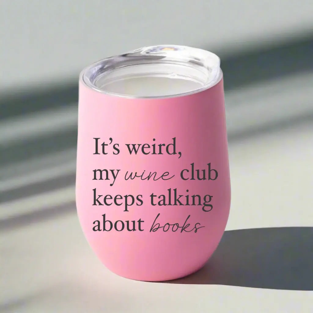 Stemless wine tumbler from Winks Design Studio with "My Wine Club Keeps Talking About Books" printed in black text.