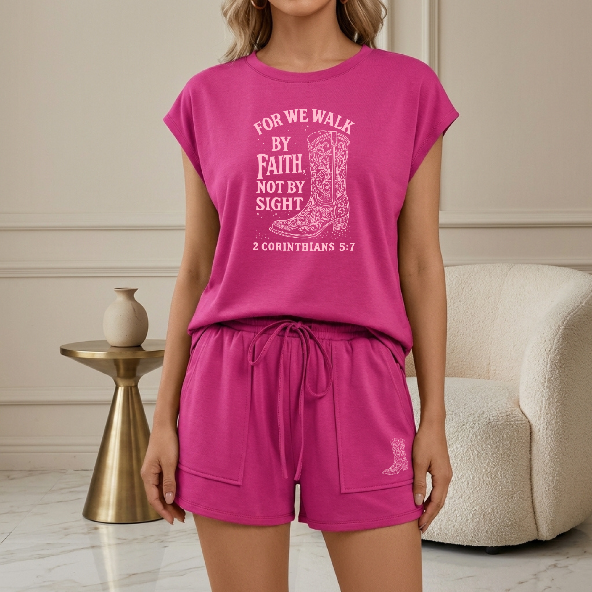 Person wearing a pink outfit with a motivational quote on a plain background