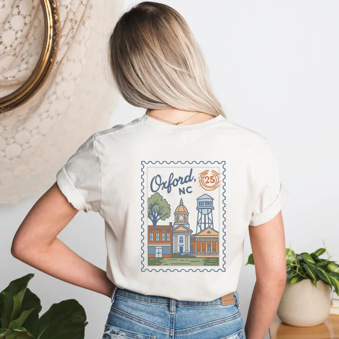 Winks Design Studio Oxford NC Postmark T-shirt featuring a casual fit with a postal-themed graphic on soft fabric.