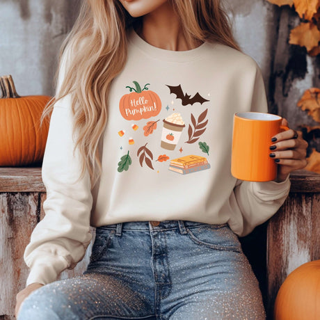 "Woman wearing Pumpkin Patch Fall-Themed Crewneck with autumn illustrations, holding an orange mug, surrounded by pumpkins"