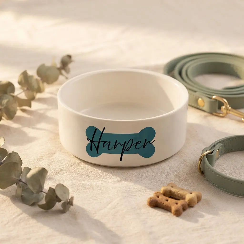 Custom Bone Ceramic Dog Bowl by Winks Design Studio features a white ceramic bowl with a bone-shaped design for pets.