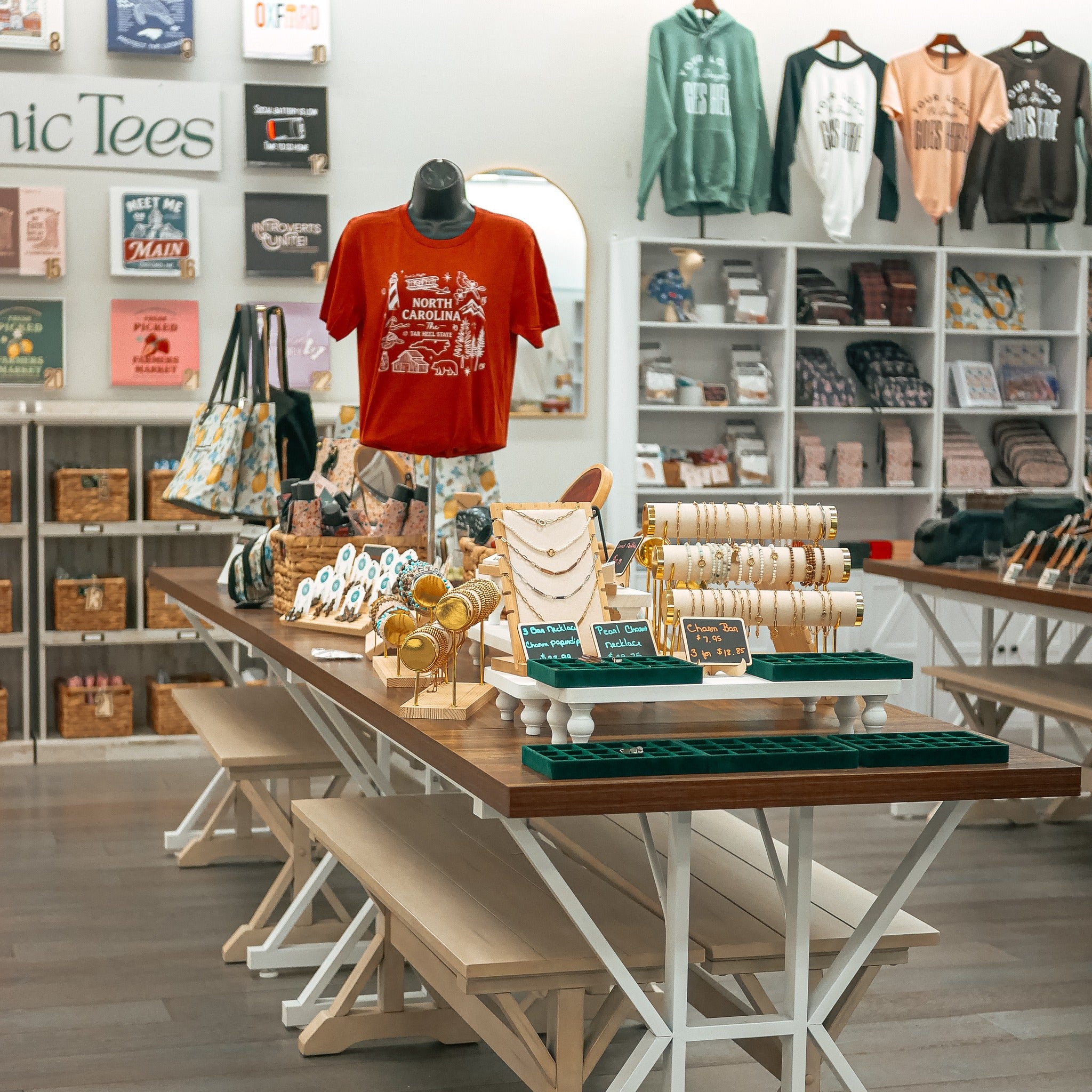 Store interior with merchandise on display, including t-shirts and jewelry.