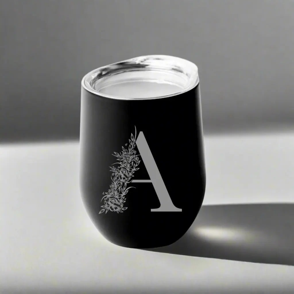 Custom floral monogram 12oz stemless wine tumbler by Winks Design Studio, LLC with intricate floral design and personalized monogram.