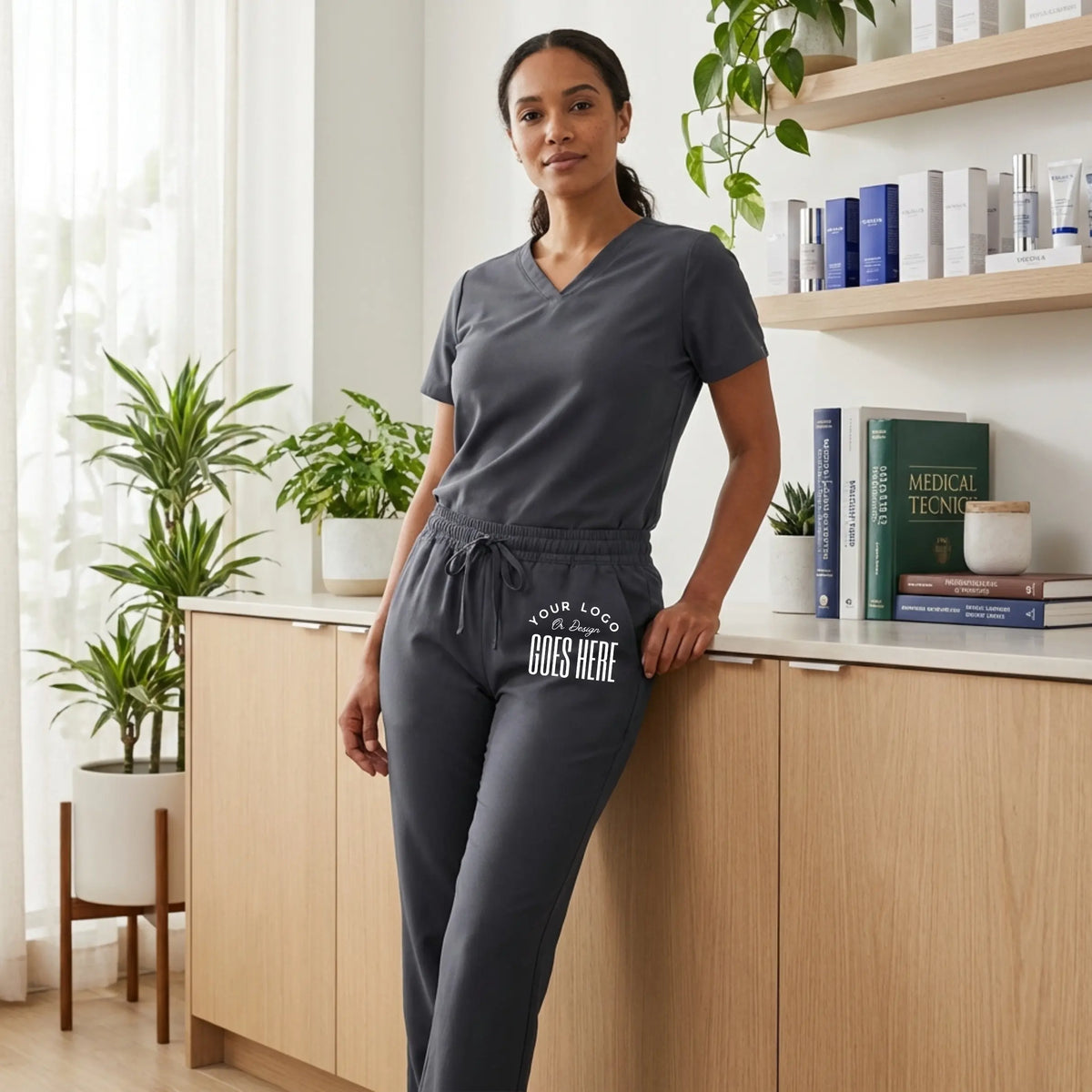 Custom Jaanuu unisex Rhodes straight-leg scrub pants, navy blue, with functional pockets, made by Winks Design Studio LLC.