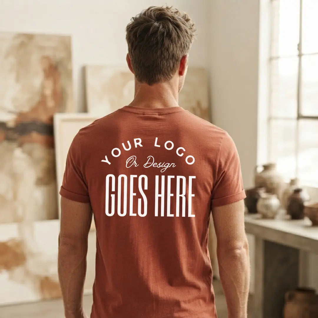 Back view of a rust custom t-shirt with a large white "Your Logo or Design Goes Here" full back placeholder print