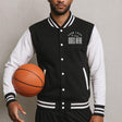 Person wearing a customizable black and white varsity jacket holding a basketball.
