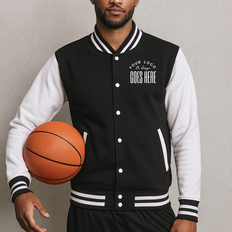 Person wearing a customizable black and white varsity jacket holding a basketball.
