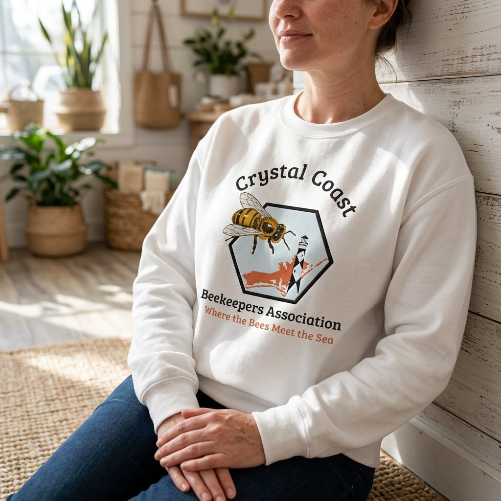 Winks Design Studio LLC Crystal Coast beekeepers crewneck sweatshirt in navy with bee and honeycomb graphic on front.