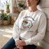 Winks Design Studio LLC Crystal Coast beekeepers crewneck sweatshirt in navy with bee and honeycomb graphic on front.