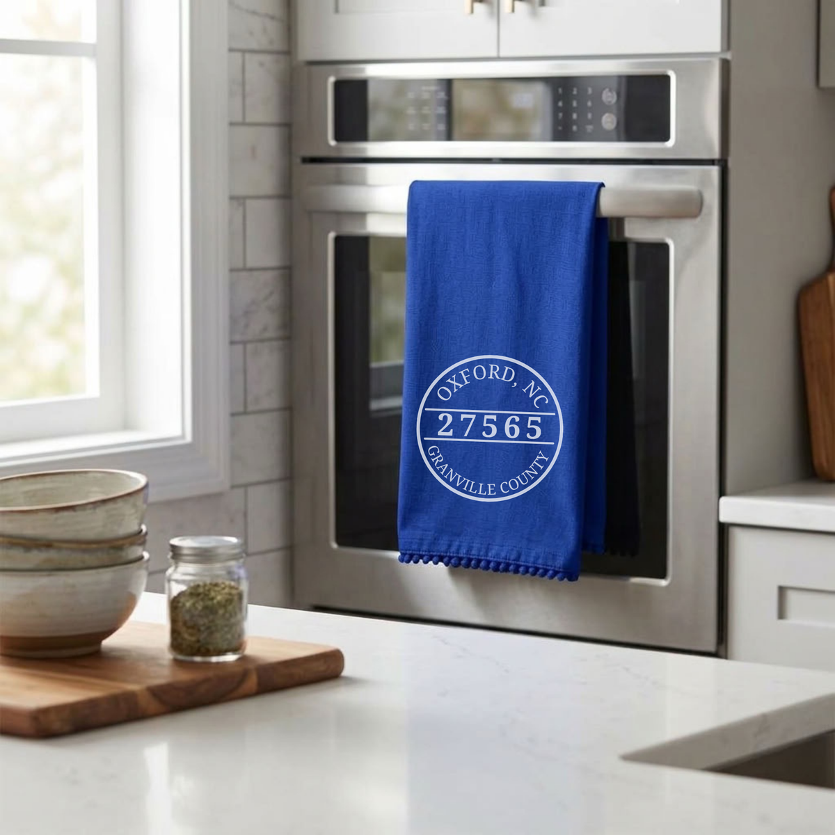 A royal blue kitchen towel with a white circular &