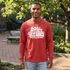 A man wearing a red long-sleeve t-shirt with a white graphic print that reads &