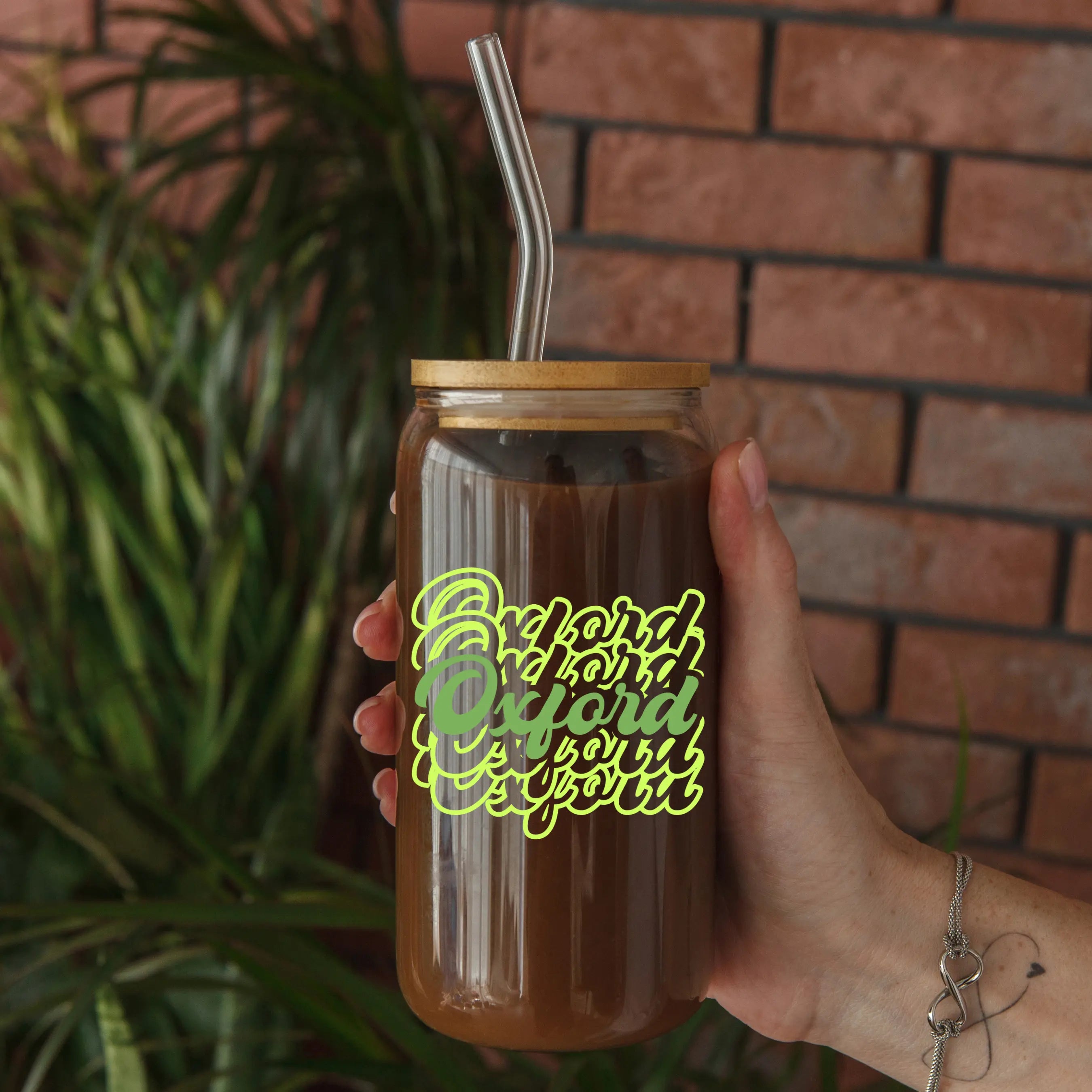 Clear glass beer can with Oxford Script design, 20oz capacity, by Winks Design Studio, LLC, shown filled with beverage.