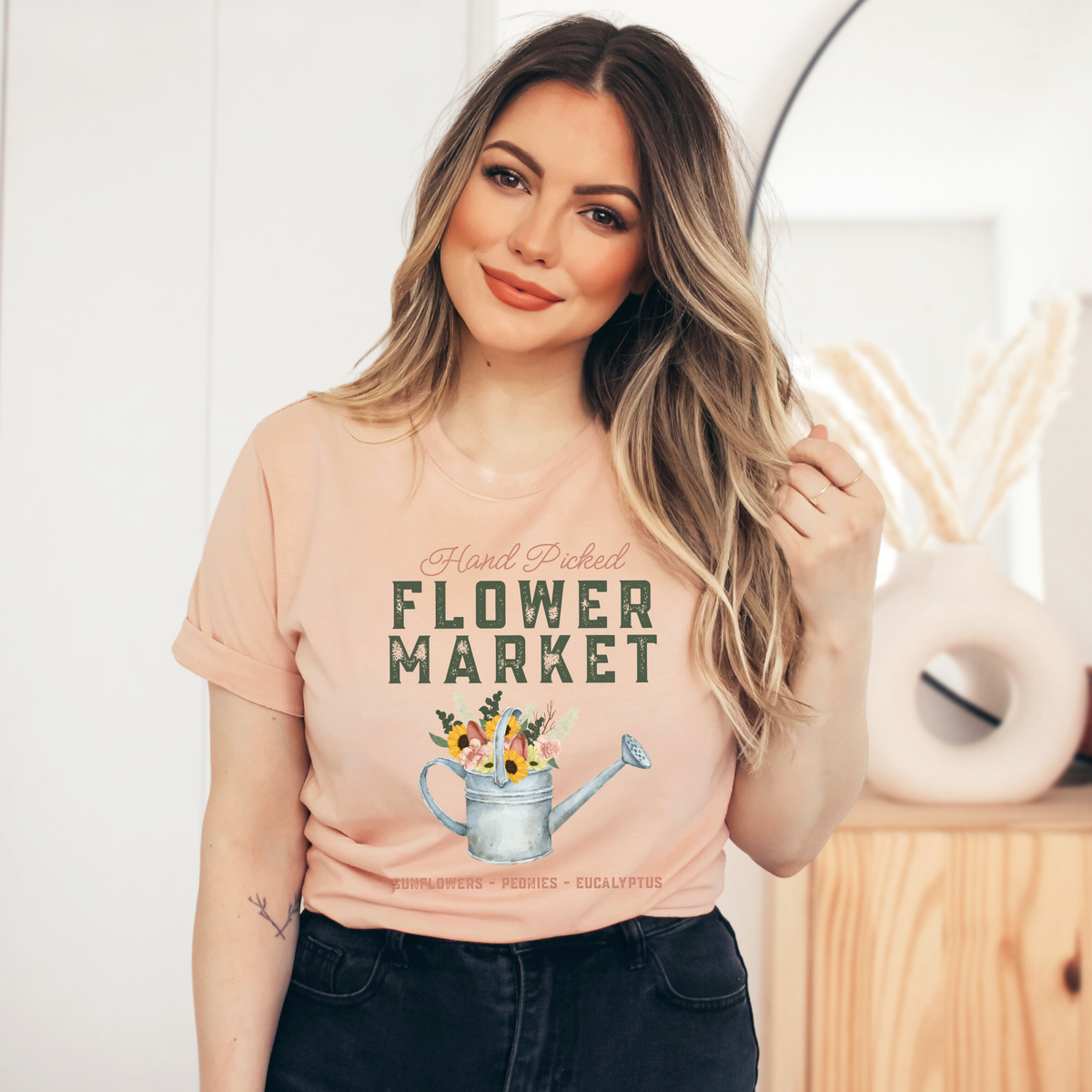 Winks Design Studio Flower Market graphic tee featuring colorful flower illustrations on a casual shirt.