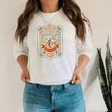 Woman wearing 2024 NC Hot Sauce Contest & Festival Long Sleeve shirt with vintage label design