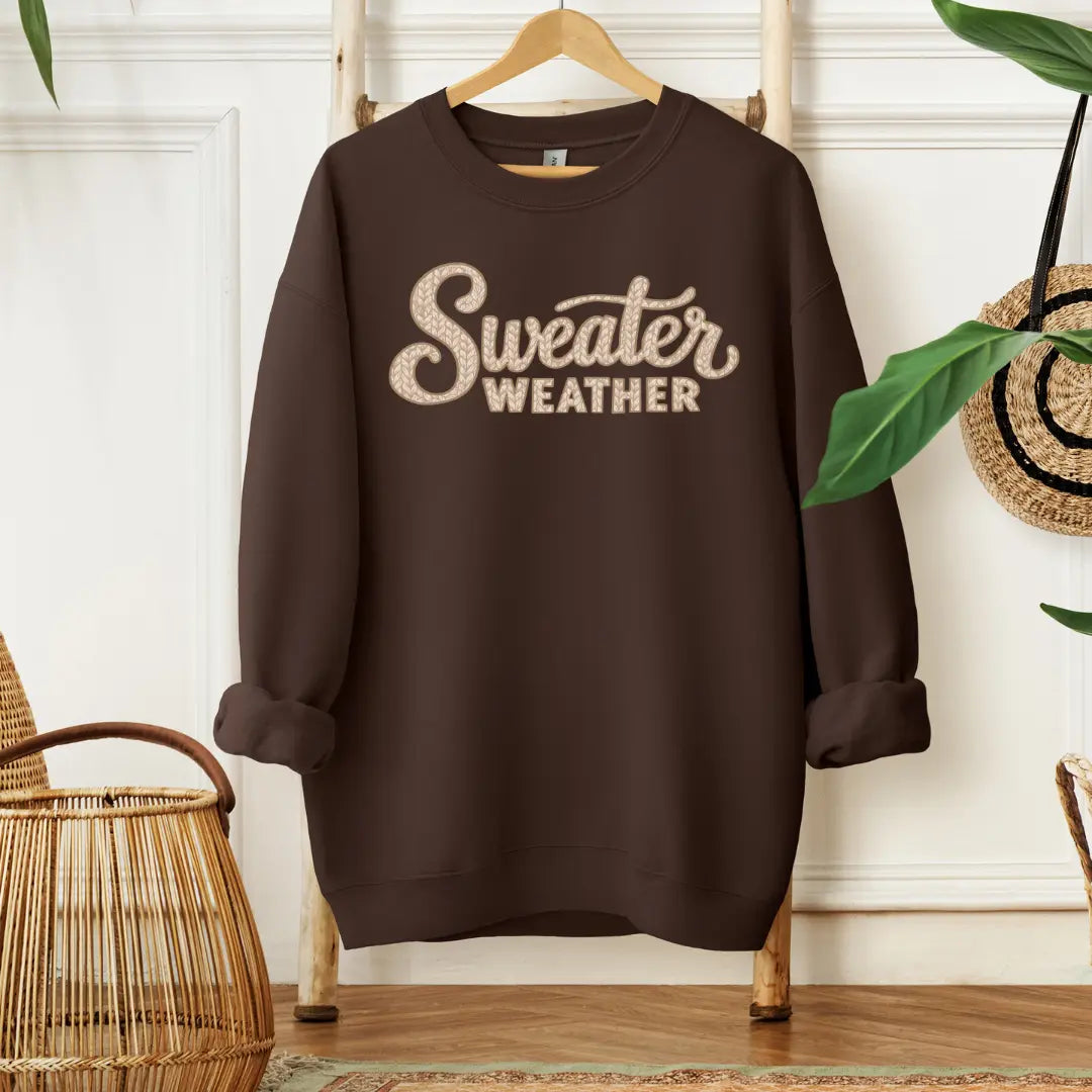 Cozy knit crewneck sweatshirt from Winks Design Studio featuring "Sweater Weather" typography, perfect for casual fall wear.
