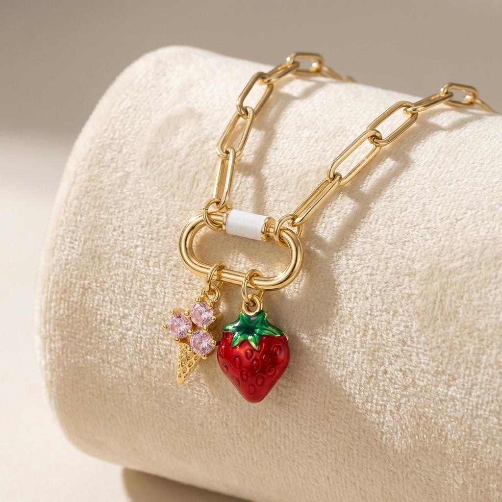 Gold enamel strawberry ice cream cone charm from Winks Design Studio, LLC, perfect for summer jewelry and charm collections.