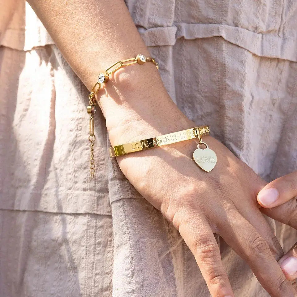 Gold-plated Love Languages Heart Charm Bangle bracelet with engraved heart charm, stylish jewelry by Winks Design Studio LLC.