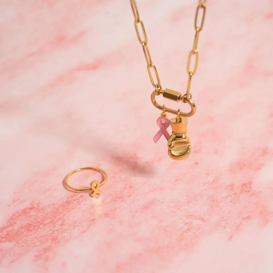 18K gold pink cancer ribbon charm by Winks Design Studio, LLC, featuring a delicate pink ribbon design for cancer awareness.