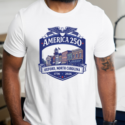 A man wearing a white short-sleeve t-shirt with a blue and navy graphic on the chest that reads &