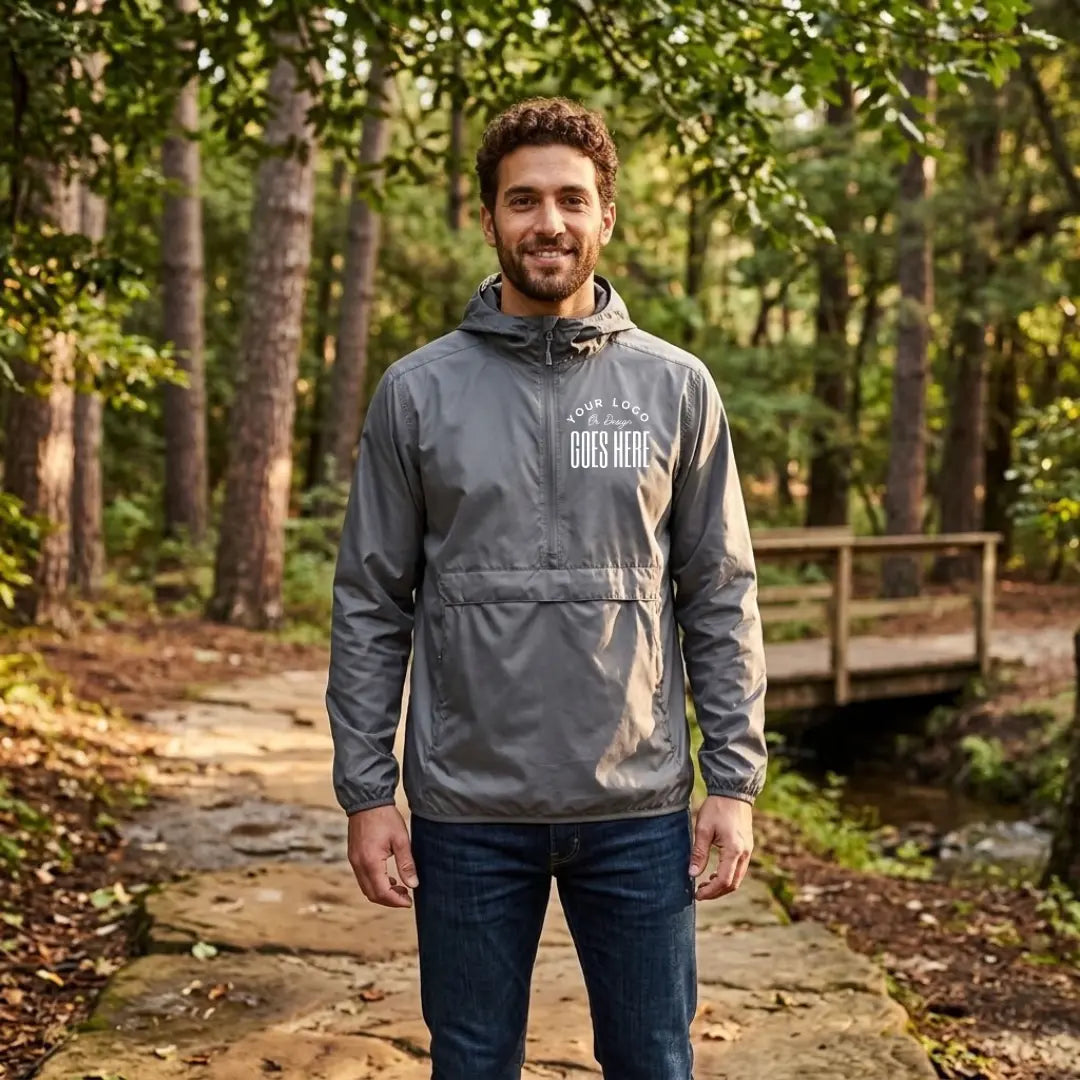Graphite gray custom quarter zip pullover windbreaker with a white "Your Logo or Design Goes Here" left chest placeholder print