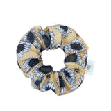 Sunflower scrunchie with vibrant yellow and black sunflower design on soft cotton fabric.