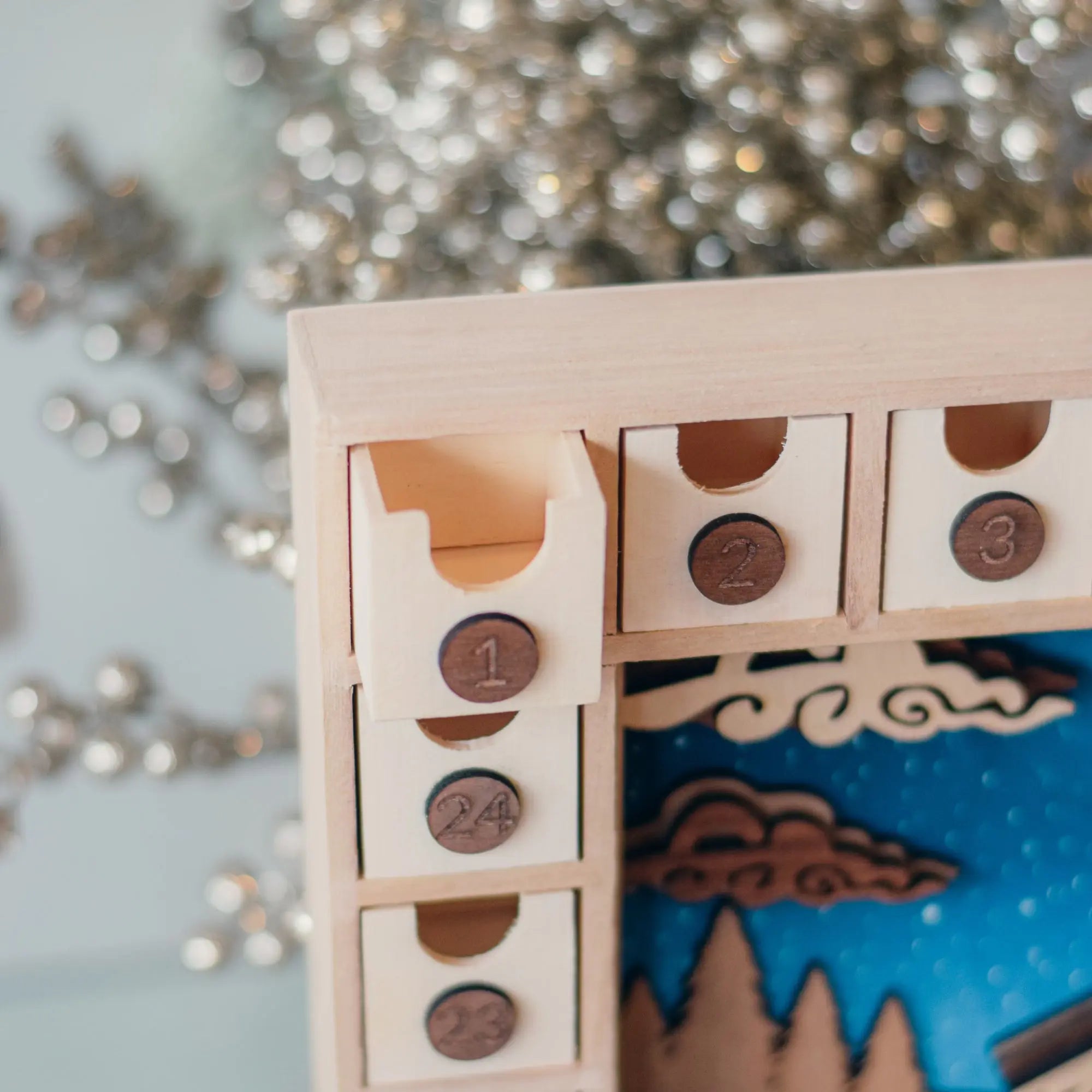 Nativity Advent Calendar Workshop Kit by Winks Design Studio, LLC with colorful paper pieces and craft supplies for holiday decoration