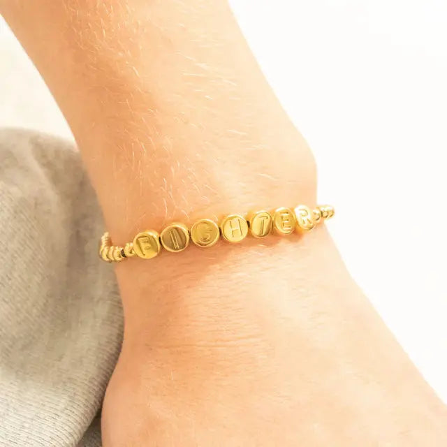 18K gold fighter metal bead bracelet by Winks Design Studio, LLC, featuring sleek metal beads on a stylish bracelet.