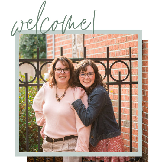 Owners smiling near a fence graphic