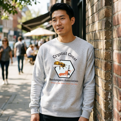 Cream-colored crewneck sweatshirt featuring a Crystal Coast Beekeepers design by Winks Design Studio, LLC, with bee and honeycomb graphics.