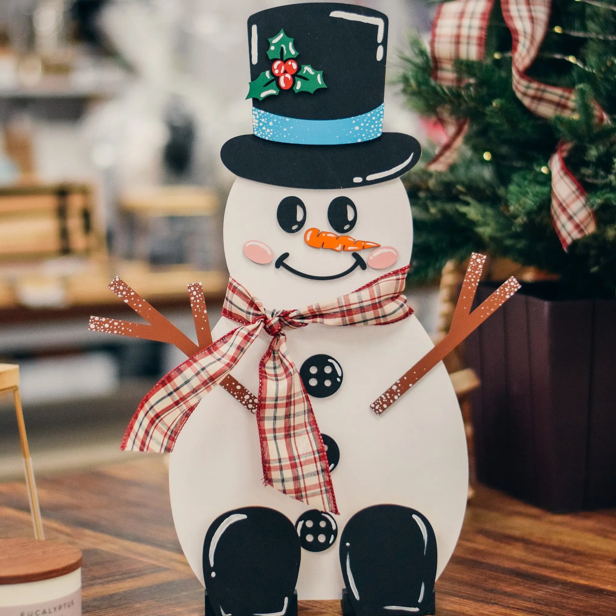 DIY Wooden Snowman Craft Kit by Winks Design Studio, LLC, with paint and accessories for creating holiday decorations.