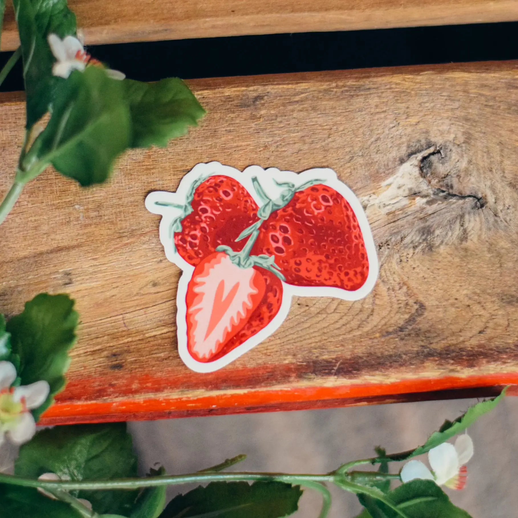 Fresh picked strawberry sticker by Winks Design Studio, LLC, featuring a bright, realistic strawberry illustration on a white background.
