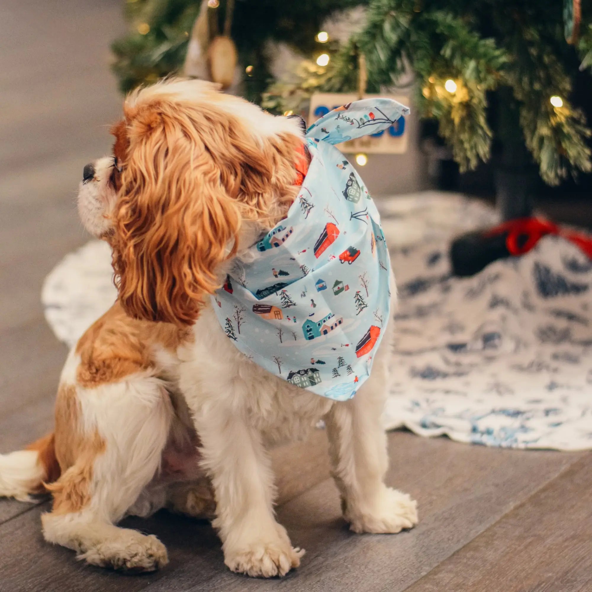 Christmas Village Dog Bandana by Winks Design Studio, LLC, featuring festive holiday village print on soft fabric for pets.