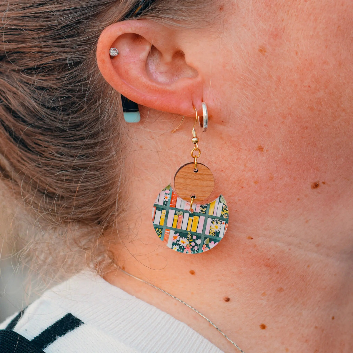 Winks Design Studio LLC bookshelf statement earrings with geometric book-shaped design, gold-tone metal, and modern fashion style.