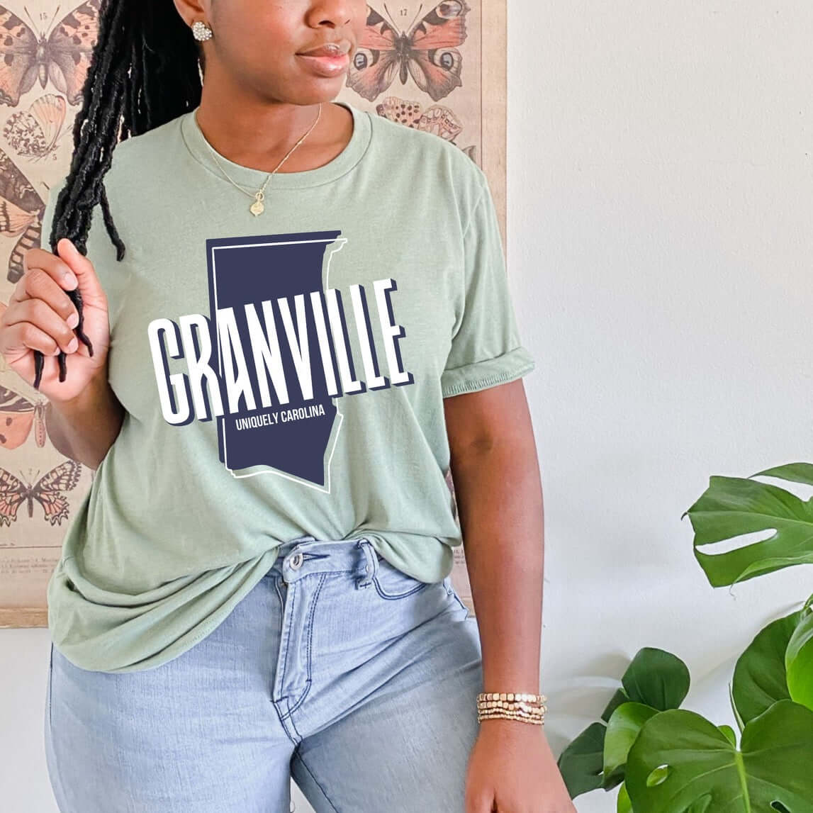 Woman wearing a Granville NC Map T-shirt in light green, featuring a detailed map design, showcasing North Carolina pride.