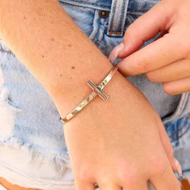 Philippians 4:13 Cross cuff bracelet by Winks Design Studio in 18K gold, featuring a cross charm and engraved scripture detail.