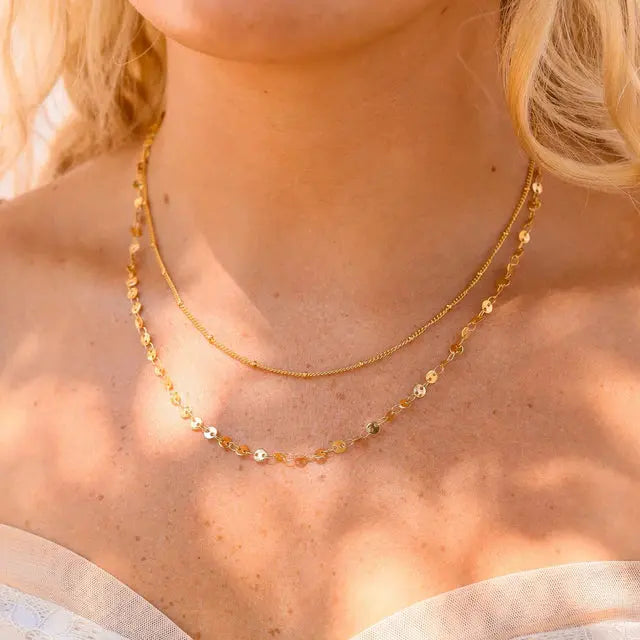 18K gold layered necklace with circle and satellite chain design, featuring delicate chain links and elegant craftsmanship.