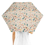 Person holding a stylish Terrazzo Umbrella with colorful, modern pattern design