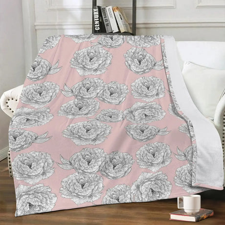 Pink Peony Flower Blanket draped over a white chair, featuring hand-drawn peony flowers on a soft pink background.