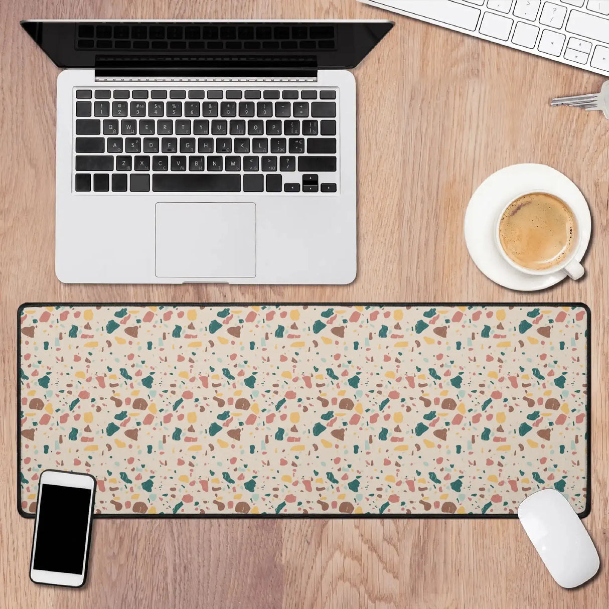 Terrazzo desk mat on wooden desk with laptop, coffee, phone, and mouse, adding modern elegance and style to your workspace.