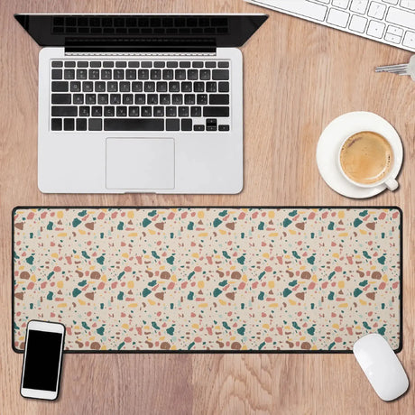 Terrazzo Desk Mat on wooden desk with laptop, coffee cup, mouse, and smartphone, showcasing modern workspace elegance.