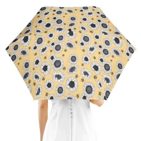 Person holding Sunflower Umbrella with vibrant sunflower pattern, perfect for rainy days and UV protection.