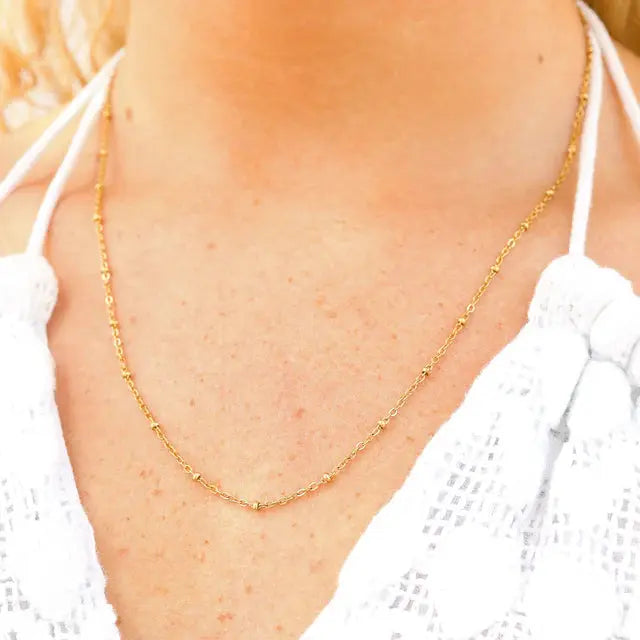 18K gold satellite chain necklace from Winks Design Studio, LLC, featuring a delicate, interconnected circular link design.