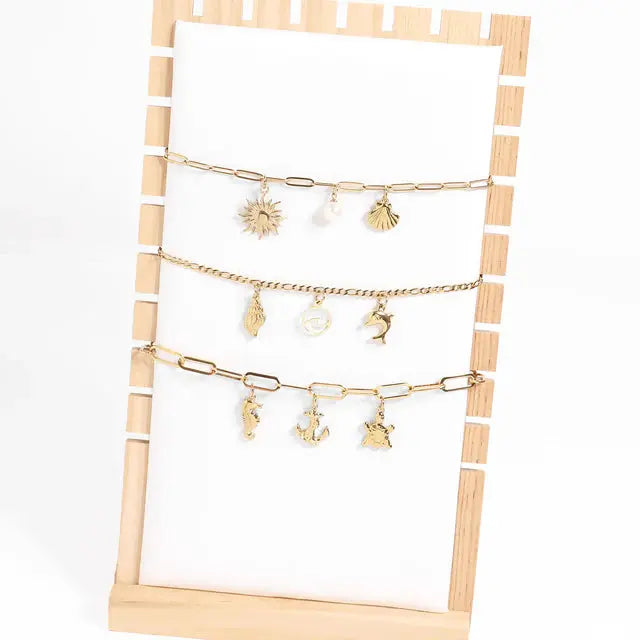 Gold sea charm by Winks Design Studio, LLC featuring nautical design, perfect for jewelry or accessories.