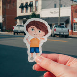 Cartoon sticker of Max from Max's Festival Adventure held in hand with city street background