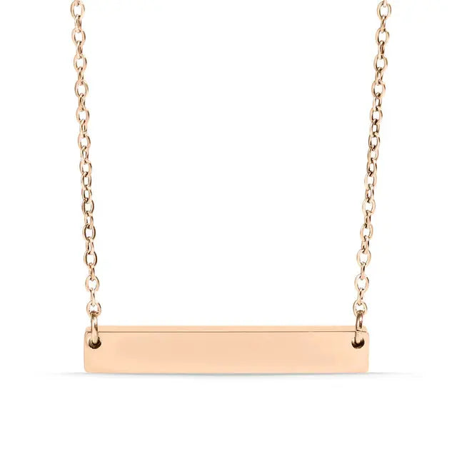Rose gold engraved bar necklace by Winks Design Studio, LLC, featuring a personalized stainless steel pendant on a delicate chain.