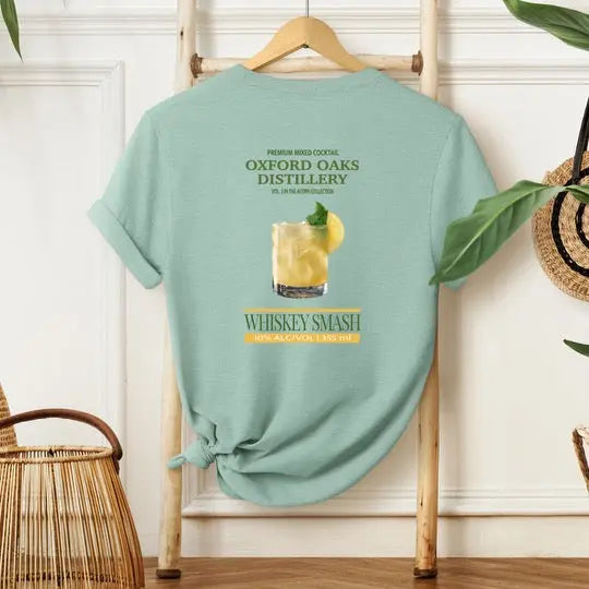 Winks Design Studio LLC Whiskey Smash T-shirt featuring a stylish graphic design with Oxford Oaks Distillery branding.