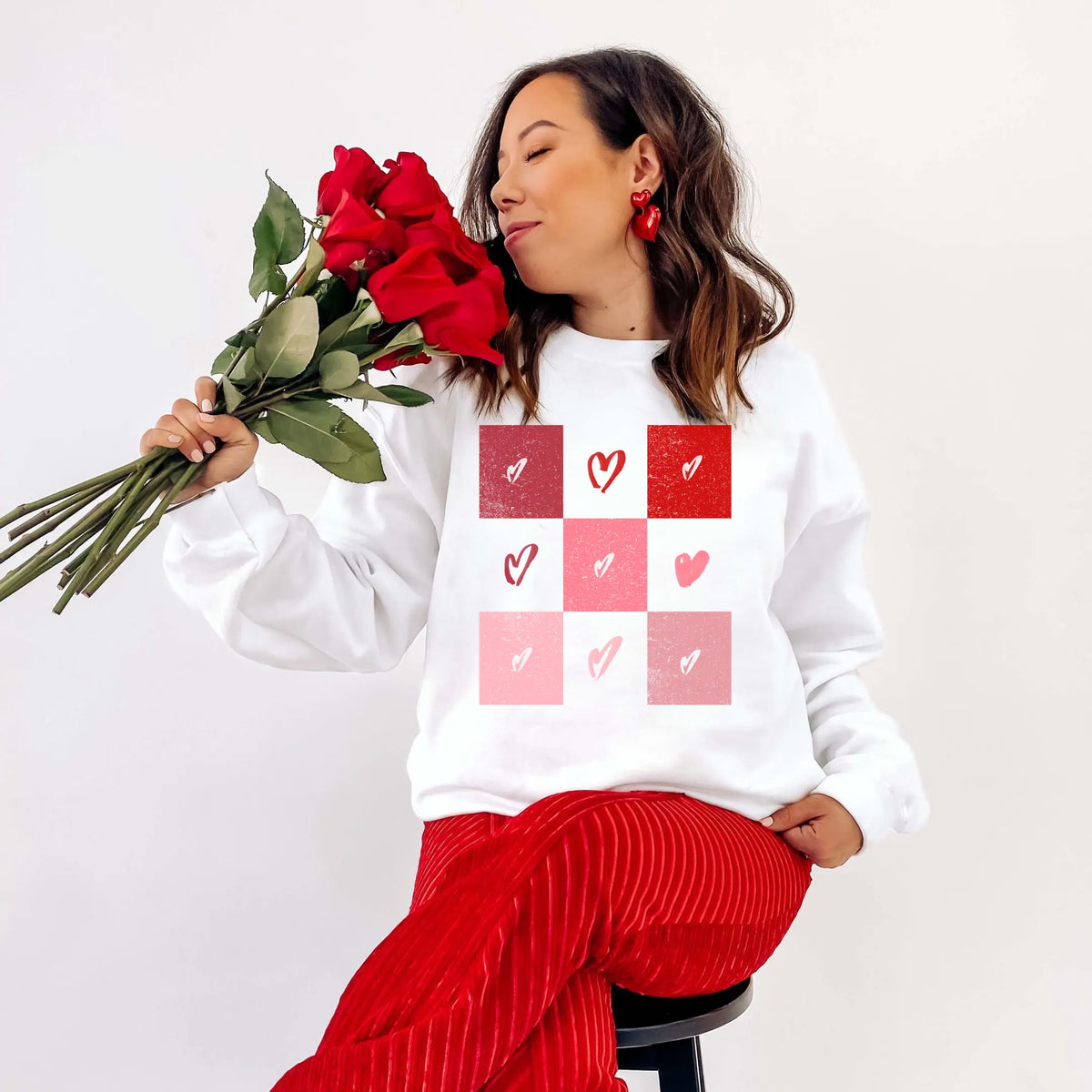 Checkerboard heart crewneck by Winks Design Studio, LLC featuring a bold checkerboard pattern and a heart graphic on soft fabric.