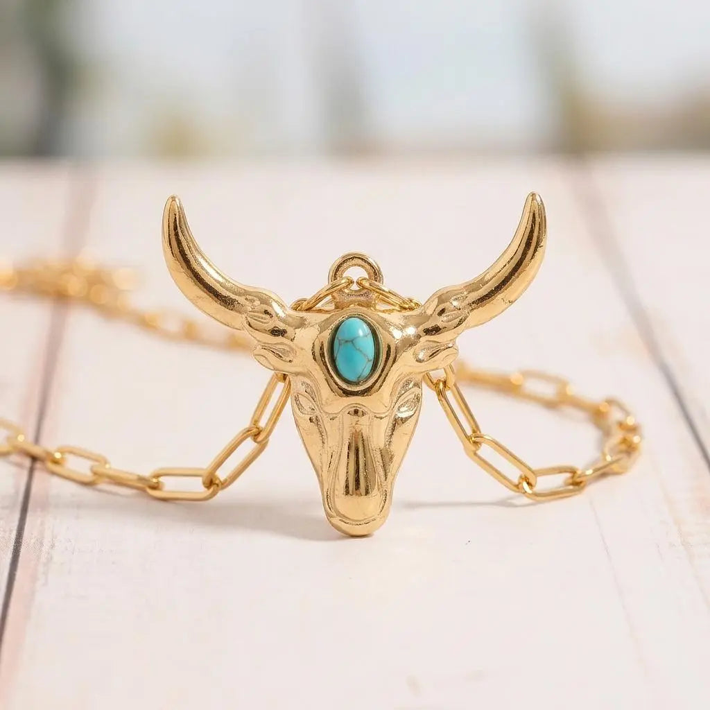 Longhorn charm jewelry by Winks Design Studio featuring a detailed longhorn steer with turquoise accents.