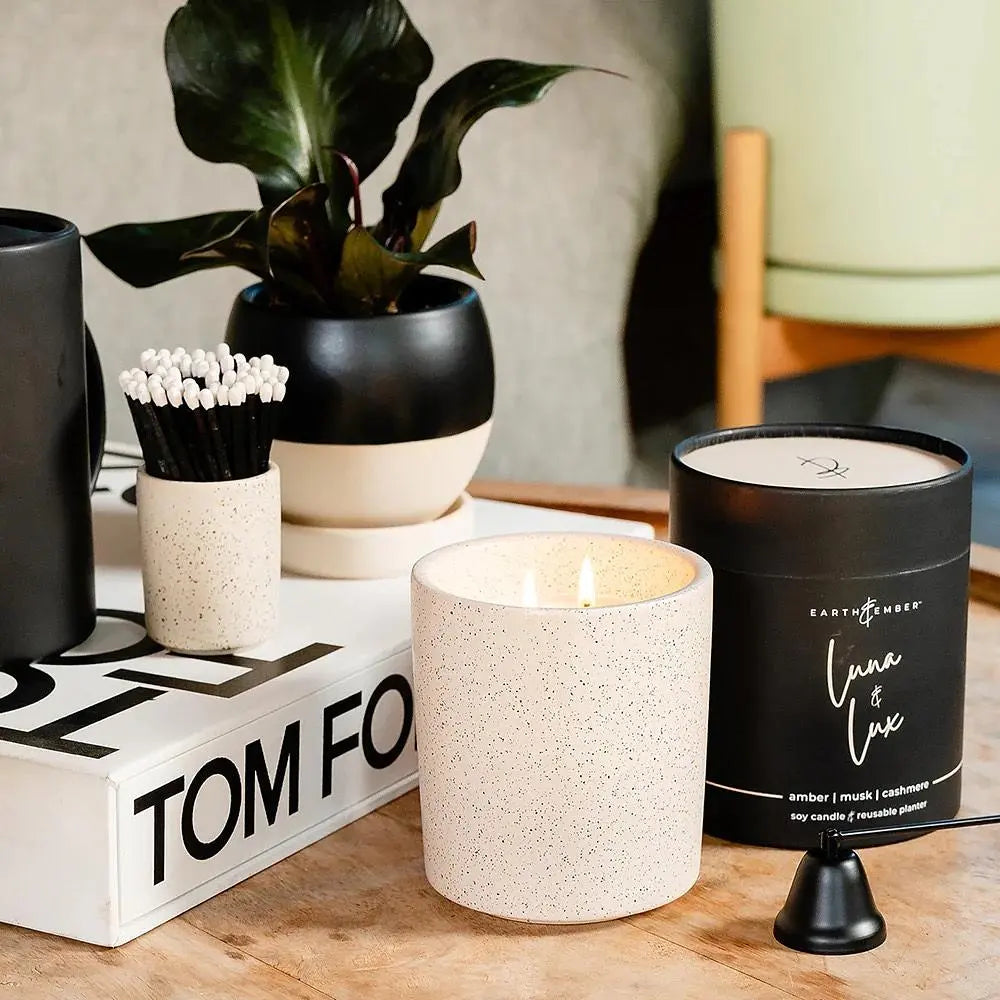 Earth &amp; Ember Luna &amp; Lux 13 oz candle by Winks Design Studio, LLC, featuring a sleek glass jar with a lit wick and ambient glow.