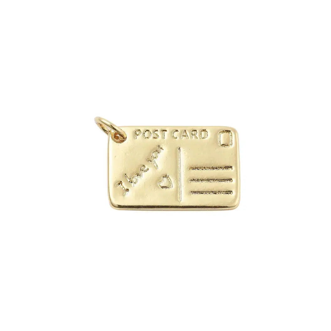 Gold post card charm by Winks Design Studio, LLC featuring detailed postcard design, ideal as a jewelry charm or accessory.